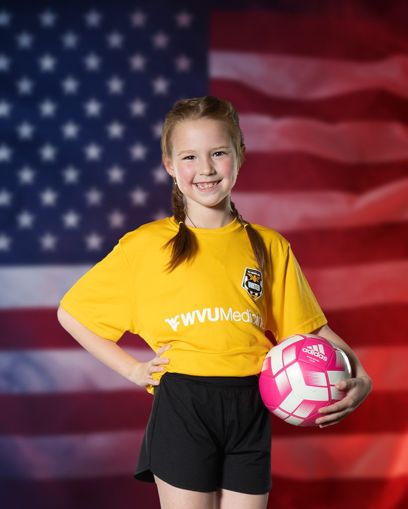 Young soccer player holding a ball for a DLS Innovations youth sports league portrait